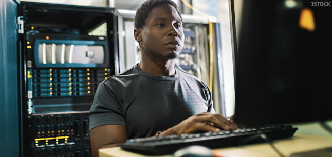 IT System administrator looking at computer screen IT System administrator looking at computer screen