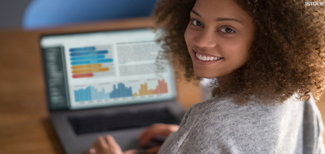 Journalist working on news story on laptop computer
