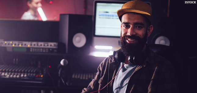 Music producer working in recording studio with music artist