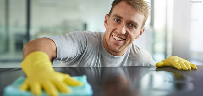Cleaner wiping off the surfaces in an office