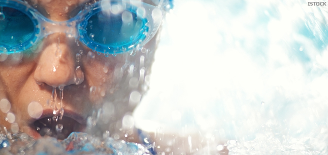 Athlete swimming in pool, wearing goggles