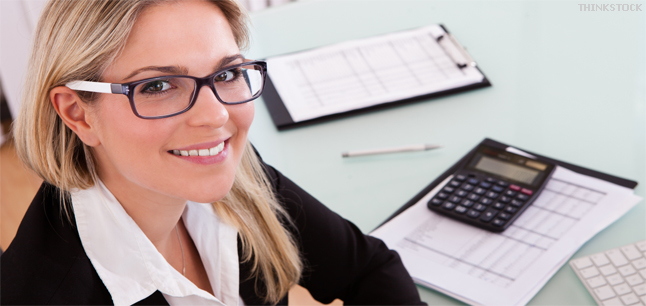 Young businesswoman calculating data in her office