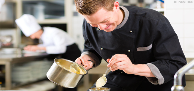 Chef in restaurant kitchen preparing a sauce