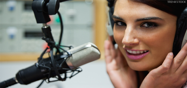 Young female presenter talking into a microphone
