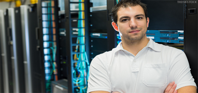 A datacenter manager in front of the datacenter equipment racks