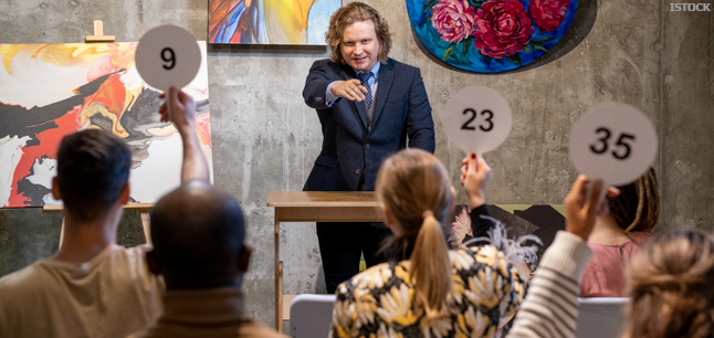 Auctioneer selling item at auction
