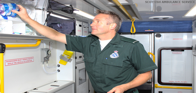Paramedic stocking up supplies in ambulance
